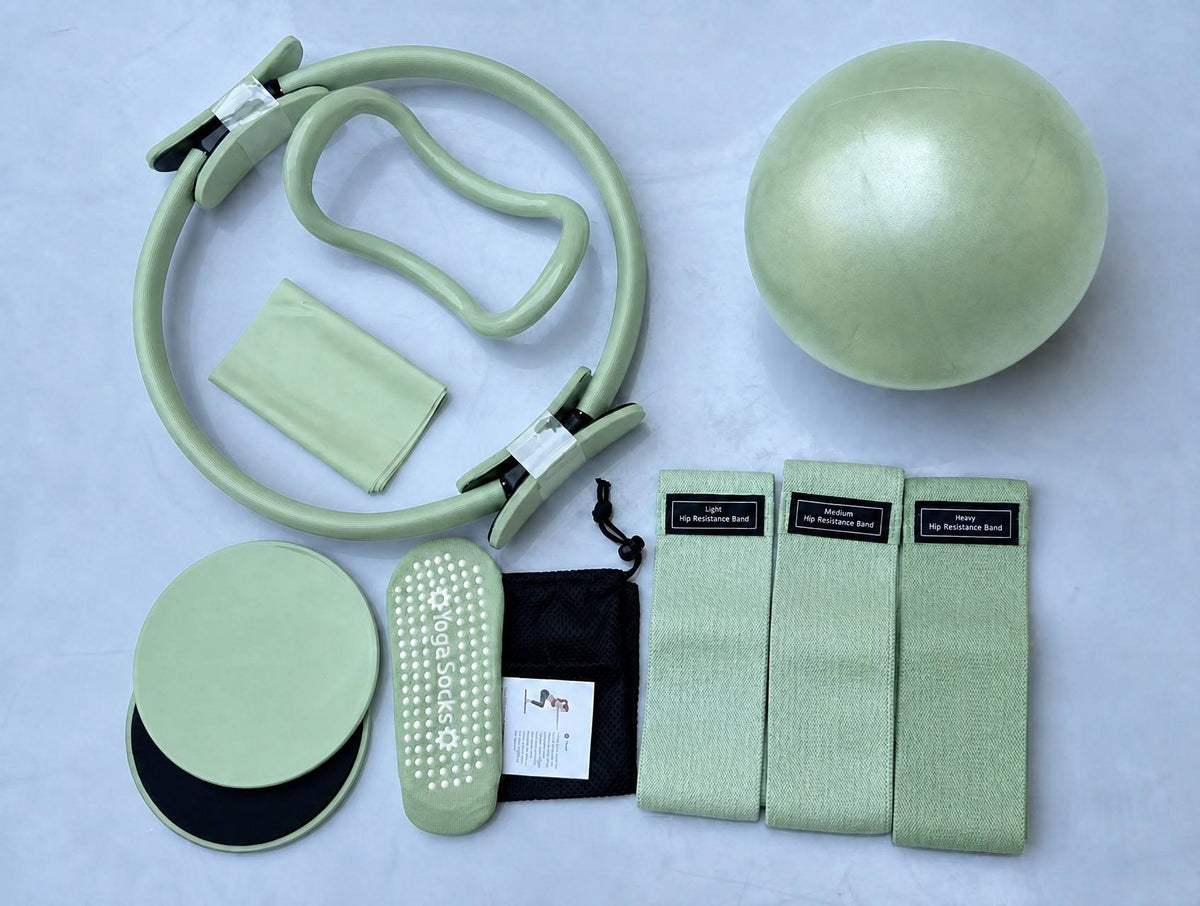 Home Pilates Essentials Kit in Sage: Pilates ring, mini ball, three fabric bands, core sliders, grip socks and bag