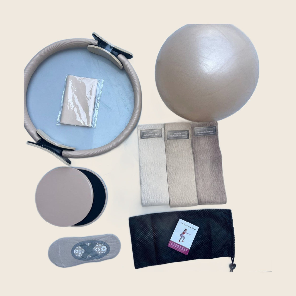 Home Pilates Essentials Kit in Sand: ring, mini ball, three fabric bands, stretch band, core sliders, grip socks and bag